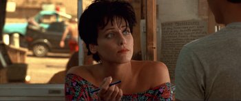 Movie still from “Point Break” (1991), directed by Kathryn Bigelow – A person holding a pen; Close Up shot, High angle