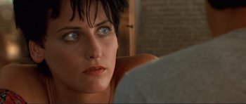 Movie still from “Point Break” (1991), directed by Kathryn Bigelow – A person with blue eyes; Close Up shot, Over the shoulder angle