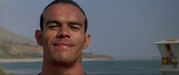 Movie still from “Point Break” (1991), directed by Kathryn Bigelow – A man's face near the ocean; Close Up shot, Low angle