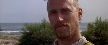 Movie still from “Point Break” (1991), directed by Kathryn Bigelow – A person with a beard and mustache; Close Up shot, Low angle