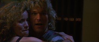 Movie still from “Point Break” (1991), directed by Kathryn Bigelow – A person with long blonde hair; Close Up shot, Low angle