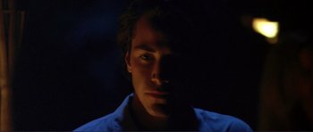 Movie still from “Point Break” (1991), directed by Kathryn Bigelow – A person's face in the dark; Close Up shot, Low angle