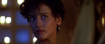 Movie still from “Point Break” (1991), directed by Kathryn Bigelow – A person with short black hair; Close Up shot, Over the shoulder angle