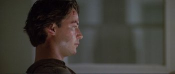 Movie still from “Point Break” (1991), directed by Kathryn Bigelow – A person looking to his left; Close Up shot, Over the shoulder angle