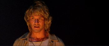 Movie still from “Point Break” (1991), directed by Kathryn Bigelow – A person with long blonde hair; Close Up shot, Low angle