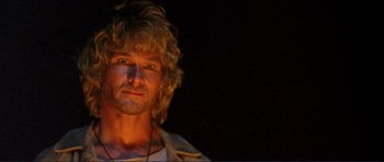 Movie still from “Point Break” (1991), directed by Kathryn Bigelow – A person with long blonde hair; Close Up shot, Low angle