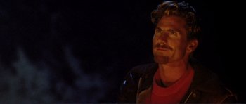 Movie still from “Point Break” (1991), directed by Kathryn Bigelow – A person wearing a red shirt; Close Up shot, Low angle