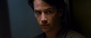 Movie still from “Point Break” (1991), directed by Kathryn Bigelow – A person wearing a shirt; Close Up shot, Low angle