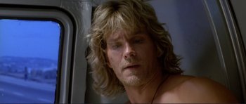 Movie still from “Point Break” (1991), directed by Kathryn Bigelow – A person with long blonde hair; Close Up shot, Low angle