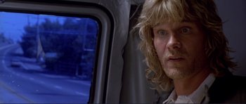 Movie still from “Point Break” (1991), directed by Kathryn Bigelow – A person with long blonde hair; Close Up shot, Low angle