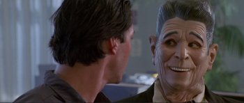 Movie still from “Point Break” (1991), directed by Kathryn Bigelow – A man is looking at another man's face; Close Up shot, Over the shoulder angle