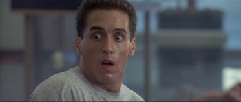 Movie still from “Point Break” (1991), directed by Kathryn Bigelow – A person with a surprised look on his face; Close Up shot, Low angle