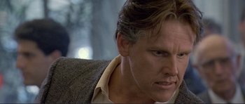 Movie still from “Point Break” (1991), directed by Kathryn Bigelow – A person wearing a suit and tie; Close Up shot, Low angle