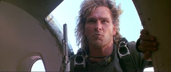 Movie still from “Point Break” (1991), directed by Kathryn Bigelow – A person holding a gun; Close Up shot, Low angle