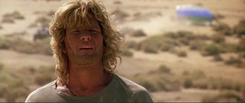 Movie still from “Point Break” (1991), directed by Kathryn Bigelow – A person with long blonde hair; Close Up shot, Low angle