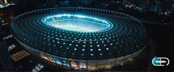 Movie still from “Pokémon: Detective Pikachu” (2019), directed by Rob Letterman – An aerial view of a stadium lit up at night; Extreme Wide shot, High angle