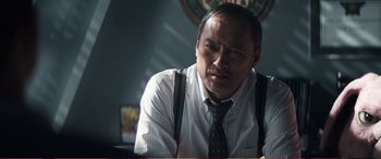 Movie still from “Pokémon: Detective Pikachu” (2019), directed by Rob Letterman – A person wearing a shirt and a tie; Close Up shot, Low angle