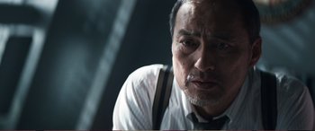 Movie still from “Pokémon: Detective Pikachu” (2019), directed by Rob Letterman – An older man wearing a white dress shirt and suspenders; Close Up shot, Low angle