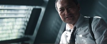 Movie still from “Pokémon: Detective Pikachu” (2019), directed by Rob Letterman – An older man wearing a suit and a tie; Close Up shot, Low angle