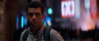 Movie still from “Pokémon: Detective Pikachu” (2019), directed by Rob Letterman – A man standing in the middle of a street; Close Up shot, Over the shoulder angle