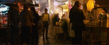 Movie still from “Pokémon: Detective Pikachu” (2019), directed by Rob Letterman – A group of people standing on a sidewalk at night; Wide shot, High angle
