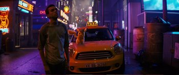 Movie still from “Pokémon: Detective Pikachu” (2019), directed by Rob Letterman – A man walking down a street next to a yellow taxi cab; Medium shot, Low angle