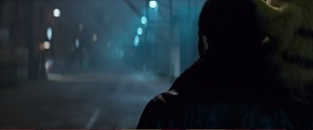 Movie still from “Pokémon: Detective Pikachu” (2019), directed by Rob Letterman – A man standing in the street at night; Close Up shot, Over the shoulder angle