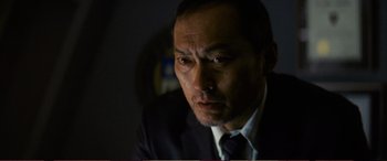 Movie still from “Pokémon: Detective Pikachu” (2019), directed by Rob Letterman – A person wearing a suit and tie; Close Up shot, Low angle