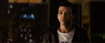 Movie still from “Pokémon: Detective Pikachu” (2019), directed by Rob Letterman – A man in a white t - shirt and a black jacket; Close Up shot, High angle