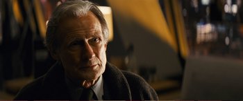 Movie still from “Pokémon: Detective Pikachu” (2019), directed by Rob Letterman – An older man wearing a suit and tie; Close Up shot, Low angle