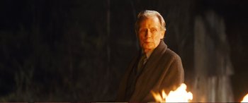 Movie still from “Pokémon: Detective Pikachu” (2019), directed by Rob Letterman – An older man in a suit and tie; Medium shot, Over the shoulder angle