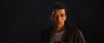 Movie still from “Pokémon: Detective Pikachu” (2019), directed by Rob Letterman – A man in a brown jacket is looking at the camera; Close Up shot, High angle