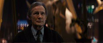 Movie still from “Pokémon: Detective Pikachu” (2019), directed by Rob Letterman – An older man wearing a suit and a tie; Close Up shot, Low angle