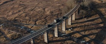 Movie still from “Pokémon: Detective Pikachu” (2019), directed by Rob Letterman – An aerial view of a bridge with a truck on it; Extreme Wide shot, High angle