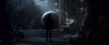 Movie still from “Pokémon: Detective Pikachu” (2019), directed by Rob Letterman – A man standing in a dark room with a large hole in the middle of the room; Extreme Wide shot, Low angle
