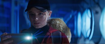 Movie still from “Pokémon: Detective Pikachu” (2019), directed by Rob Letterman – A woman in a red jacket and a black hat; Close Up shot, Over the shoulder angle