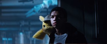Movie still from “Pokémon: Detective Pikachu” (2019), directed by Rob Letterman – A boy and a stuffed animal in a room; Close Up shot, Low angle