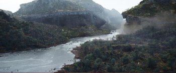 Movie still from “Pokémon: Detective Pikachu” (2019), directed by Rob Letterman – A river running through a lush green valley; Extreme Wide shot, High angle