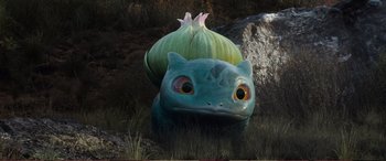 Movie still from “Pokémon: Detective Pikachu” (2019), directed by Rob Letterman – A statue of bulbasaur with a flower on its back; Close Up shot, High angle