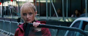 Movie still from “Pokémon: Detective Pikachu” (2019), directed by Rob Letterman – A woman leaning on the railing of a bus; Close Up shot, Low angle