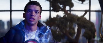 Movie still from “Pokémon: Detective Pikachu” (2019), directed by Rob Letterman – A young man is holding something in his hand; Close Up shot, Over the shoulder angle