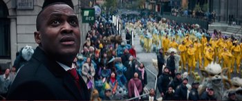 Movie still from “Pokémon: Detective Pikachu” (2019), directed by Rob Letterman – A crowd of people walking down a street; Medium shot, High angle