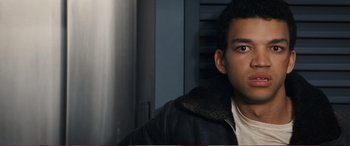 Movie still from “Pokémon: Detective Pikachu” (2019), directed by Rob Letterman – A man with a black jacket is looking at the camera; Close Up shot, Low angle