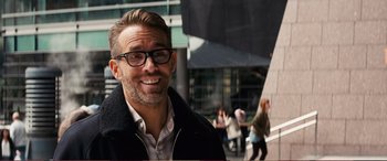 Movie still from “Pokémon: Detective Pikachu” (2019), directed by Rob Letterman – A person wearing glasses and a jacket; Close Up shot, Over the shoulder angle