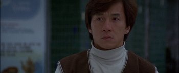 Movie still from “First Strike” (1996), directed by Stanley Tong – A person wearing a sweater; Close Up shot, Low angle
