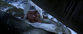 Movie still from “First Strike” (1996), directed by Stanley Tong – A man with a polar bear hat is looking out from a tent; Close Up shot, Low angle