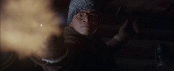 Movie still from “First Strike” (1996), directed by Stanley Tong – A man wearing glasses and a knitted hat; Close Up shot, Low angle