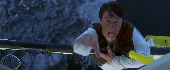 Movie still from “First Strike” (1996), directed by Stanley Tong – A man holding onto a pole with his hands; Close Up shot, Overhead angle