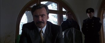 Movie still from “First Strike” (1996), directed by Stanley Tong – A man in a suit and tie next to another man in a suit and tie; Close Up shot, Low angle