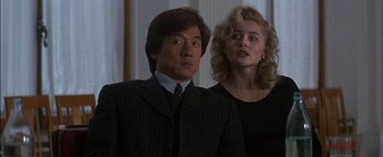 Movie still from “First Strike” (1996), directed by Stanley Tong – A man and a woman standing next to each other in a room; Close Up shot, Low angle
